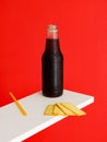 Black soft Liquid drink bottle and Cracker Biscuit isolated on red background