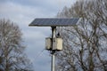 Black solar panel frozen by hoarfrost on the street. used to charge the device parking clock, information interactive screen, traf