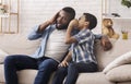 Black Son Sharing Secret With Dad, Whispering To His Ear