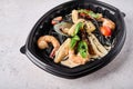 Black spaghetti nero with seafood, tomatoes and basil