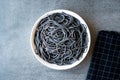 Black Spaghetti Pasta Flavored with Squid ink Cuttlefish or Inkfish. Royalty Free Stock Photo