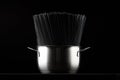 Black spaghetti pasta in a saucepan on a black background. Royalty Free Stock Photo