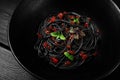 Black spaghetti with red caviar, pasta, on a black background, top view, no people, Royalty Free Stock Photo