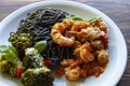 Black spaghetti with shrimp tomato sauce and baked broccoli with Roquefort cheese