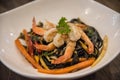 Black spaghetti with shrimps, chili