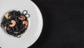 Black Spaghetti with Shrimps on White Restaurant Plate Royalty Free Stock Photo