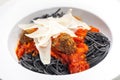 black spaghetti with tomato sauce with meat balls Royalty Free Stock Photo