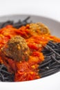 black spaghetti with tomato sauce with meat balls Royalty Free Stock Photo