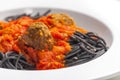 black spaghetti with tomato sauce with meat balls Royalty Free Stock Photo