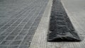 Black speed bump for slowing traffic, reduce speed down on the t