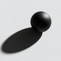 Black sphere casts a shadow on textured white background. Minimal. Royalty Free Stock Photo
