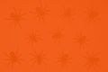 Black spiders on an orange background, color background and silhouettes of spiders, festive scary background
