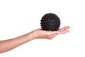 Black spiky ball massage in a female hand