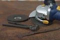 Black splitting pliers and angle grinder with thinner cut-off disc and  grinding disc on old rusty metal sheet Royalty Free Stock Photo