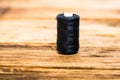 Black spool of sewing threads isolated on blurred background Royalty Free Stock Photo