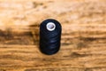 Black spool of sewing threads isolated on blurred background Royalty Free Stock Photo
