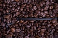 Black spoon on spilled coffee beans Royalty Free Stock Photo