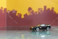 Black Sport racer car toy selective focus on blur city background