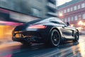 a black sports car driving down a street in the rain with buildings in the backgrouund and a blurry street light in the