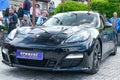 Black sports Porsche with blue decals on the front and hood