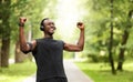 Black sportsman celebrating success, training at park Royalty Free Stock Photo