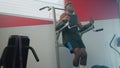 black sportsman is training alone in fitness gym, lifting legs and tensing abs, keeping fit