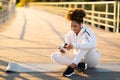 Black Sporty Woman Using Fitness Tracker App On Smartphone While Training Outdoors Royalty Free Stock Photo