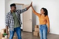 Black Spouses Giving High Five Standing Among Cardboard Boxes Indoor Royalty Free Stock Photo