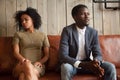 Black spouses sitting on couch aside not ready to compromise Royalty Free Stock Photo