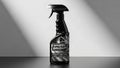 Black spray bottle labeled as window cleaner on a plain background Royalty Free Stock Photo