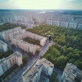 Black spy drone flying under summer city in evening. Military technology, buildings, roads, civilian town. War in
