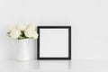 Black square frame mockup with a bouquet of white roses in a vase on a white table Royalty Free Stock Photo