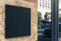 Black square signboard on the marble wall of a modern business center