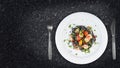 Black squid ink Fettuccine pasta with prawns or shrimps cherry tomatoes, parsley, chili in wine and butter sauce Royalty Free Stock Photo