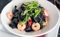 Black squid ink pasta with prawns and chili