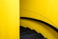 Black staircase with yellw wall background and black bannister