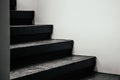 Black stairway steps with white wall - dark shadow monotone image Royalty Free Stock Photo