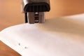 Black stapler piercing papers closeup - Image