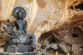 Black statue of Buddha in the cave temple