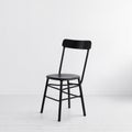 Black steel chair in the interior of a room on white background Royalty Free Stock Photo