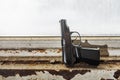Black steel gun is set on window sill barrel up Royalty Free Stock Photo
