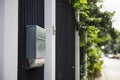 A black steel modern home fence with a plastic door bell and aluminium mail box.