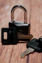 Black steel padlock with keys on a wooden background. Concept of security and tranquility Royalty Free Stock Photo