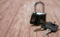 Black steel padlock with keys on a wooden background. Concept of security and tranquility Royalty Free Stock Photo