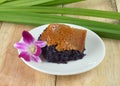 Black sticky rice with steamed custard on wooden background