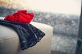 Black stocking and red thong lying on sofa in hotel room in front of window Royalty Free Stock Photo