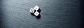 Black stone blackboard with playing dice on Royalty Free Stock Photo