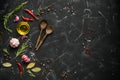 Black stone culinary background with seasonings, spices, vegetables, oil. Top view, flat lay, copy space Royalty Free Stock Photo