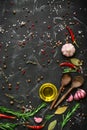 Black stone culinary background with seasonings, spices, vegetables, oil. Top view, flat lay, copy space