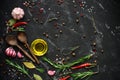 Black stone culinary background with seasonings, spices, vegetables, oil. Top view, flat lay, copy space Royalty Free Stock Photo